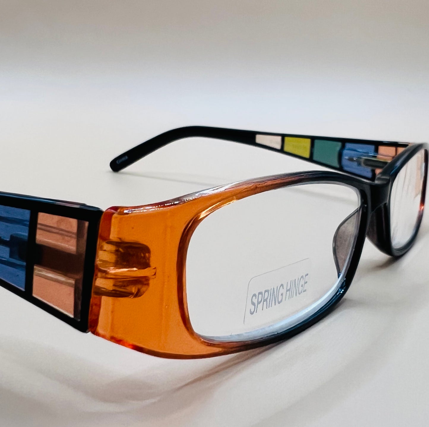 GEOMETRIC NARROW READERS.  BLACK FRAME FRONT WITH MULTI-COLOR ARMS