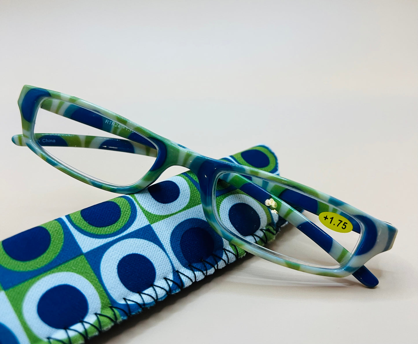 BRAND NEW GEOMETRIC NARROW READERS.  FEATURING A BLUE/GREEN MULTI-COLOR DESIGN WITH MATCHING CASE